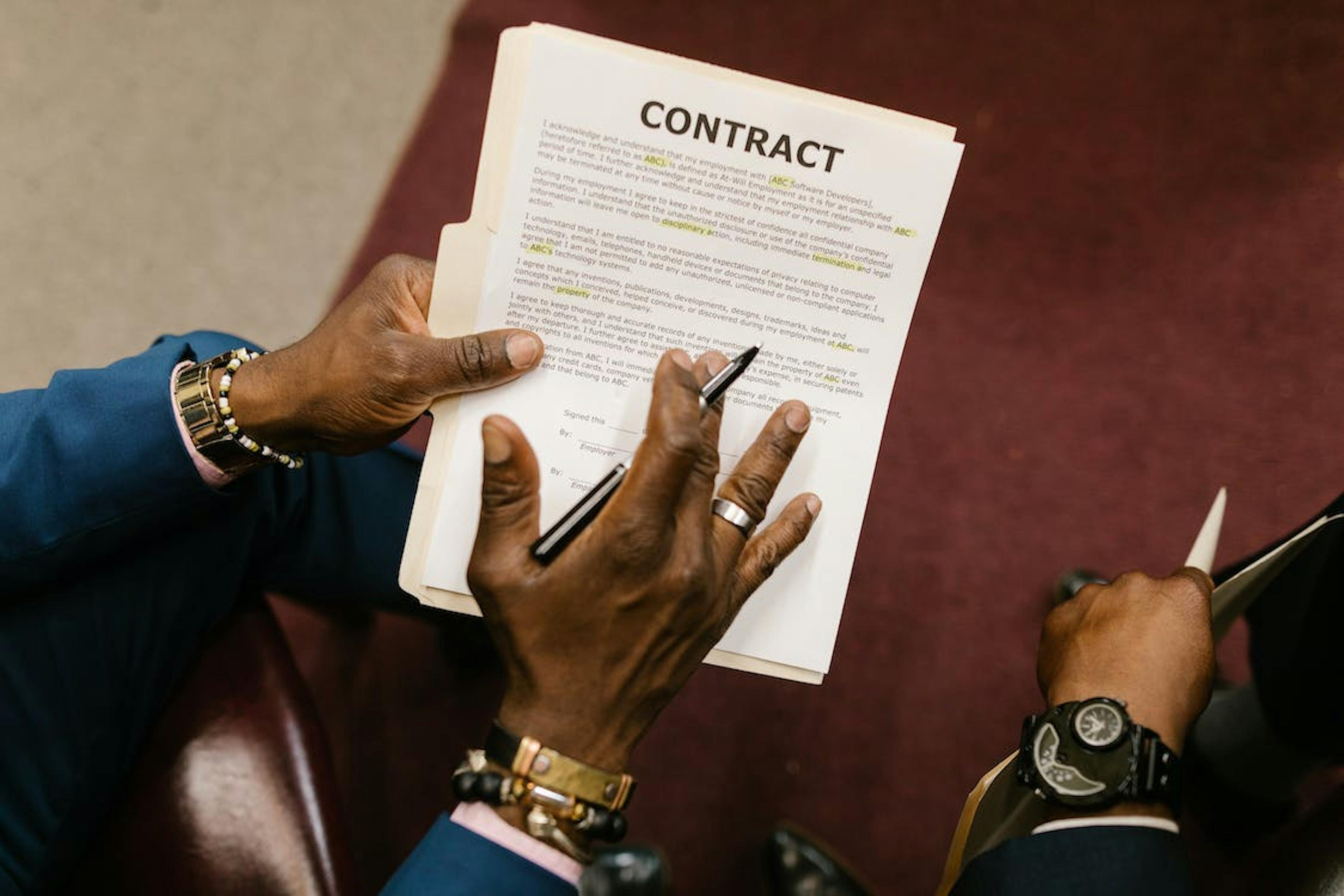 Photo by RODNAE Productions: https://www.pexels.com/photo/close-up-shot-of-a-person-holding-a-contract-7841477/