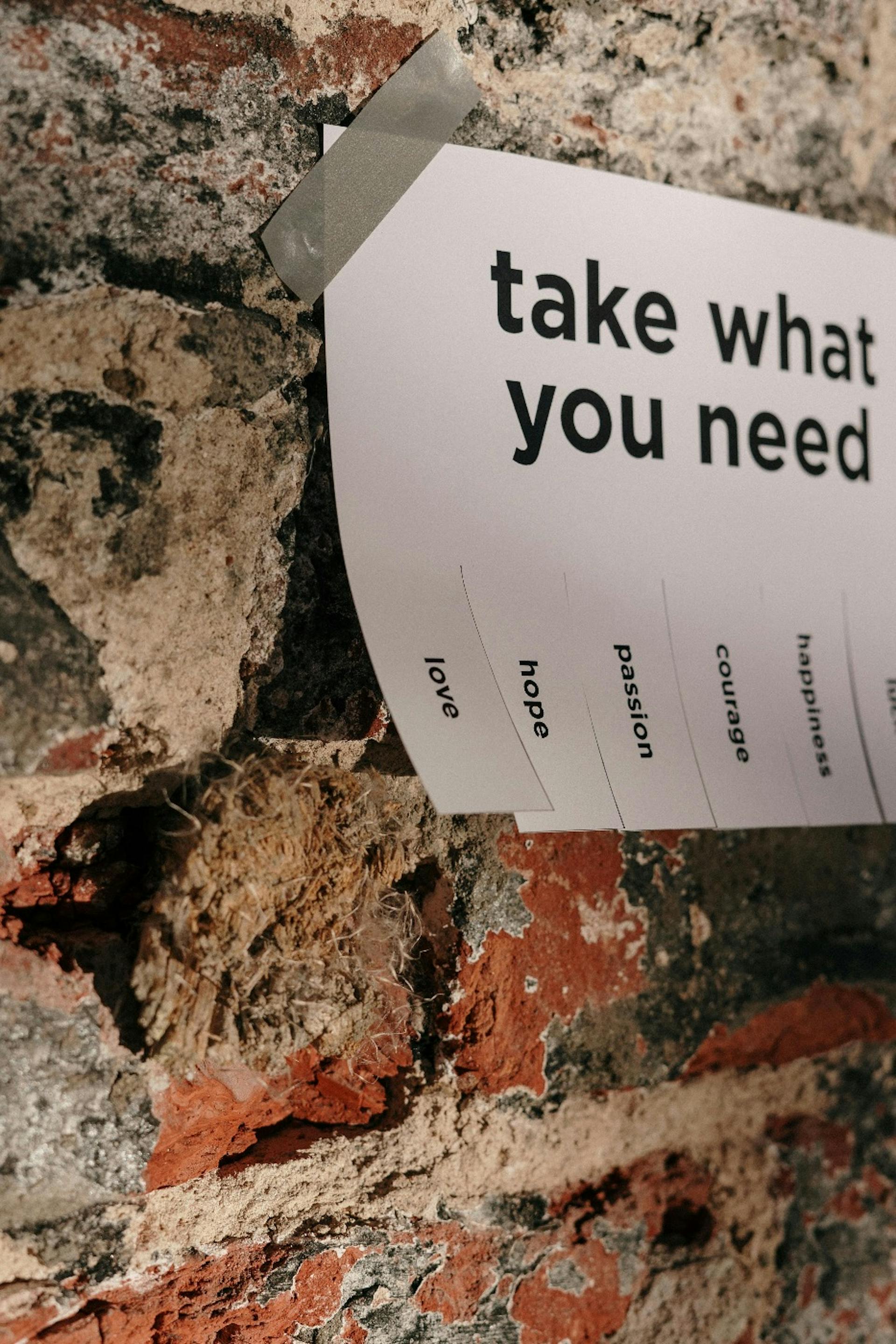 The ad on the wall which says "Take what you need" 