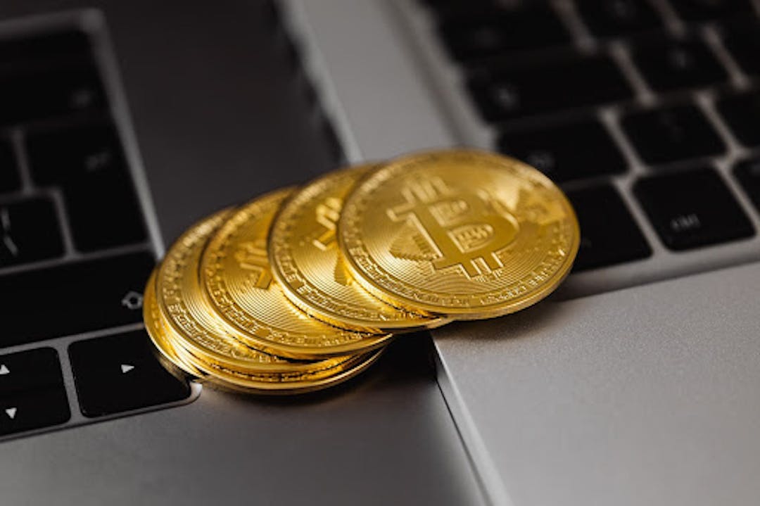 Source: https://www.pexels.com/photo/close-up-shot-of-bitcoins-on-laptop-computers-5980737/