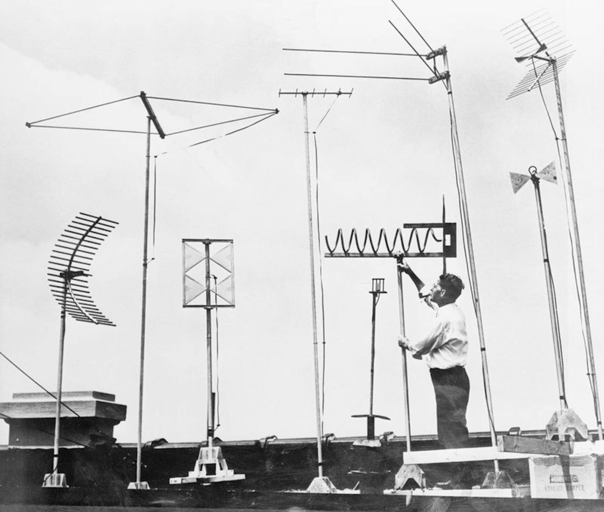 Since its founding in 1934, the Federal Communications Commission has decided which companies would have rights to which parts of the airwaves — for television and countless other technologies. Here, an RCA engineer examines an array of ultrahigh-frequency TV antennas in 1952. Credit: Bettmann Archive/Getty Images