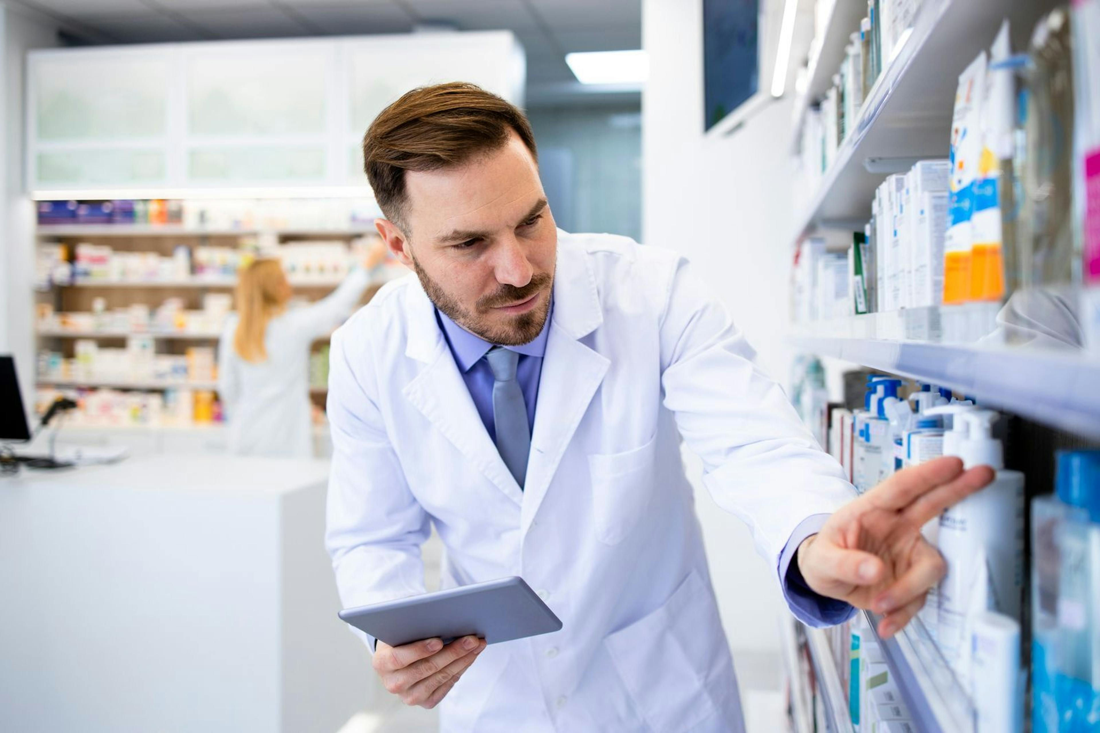 A pharmacist assessing the inventory status of medications using a tablet