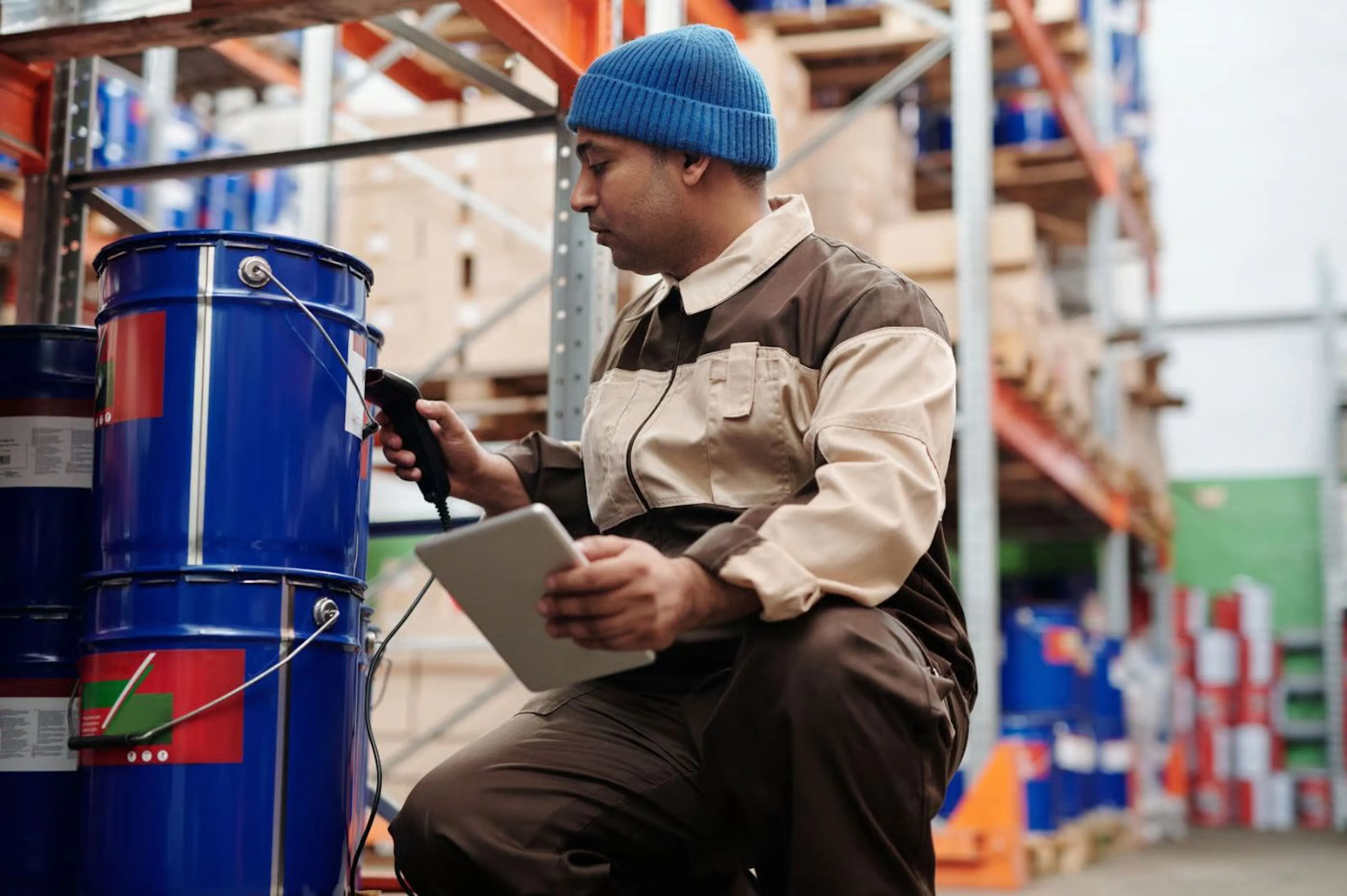 A warehouse worker scans a barcode for inventory management. Photo credit: Tiger Lily