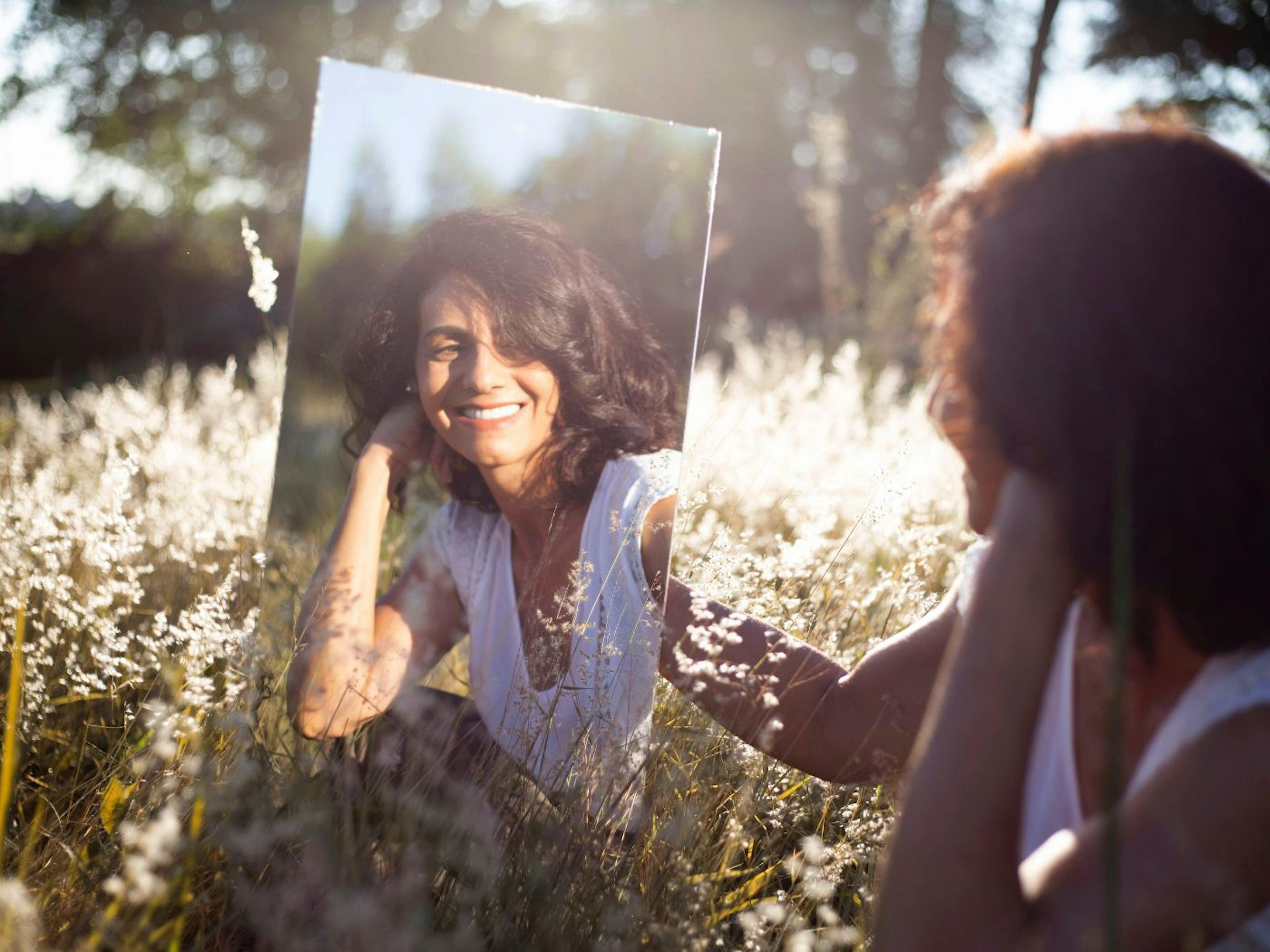 A Woman Looking at Herself in the Mirror