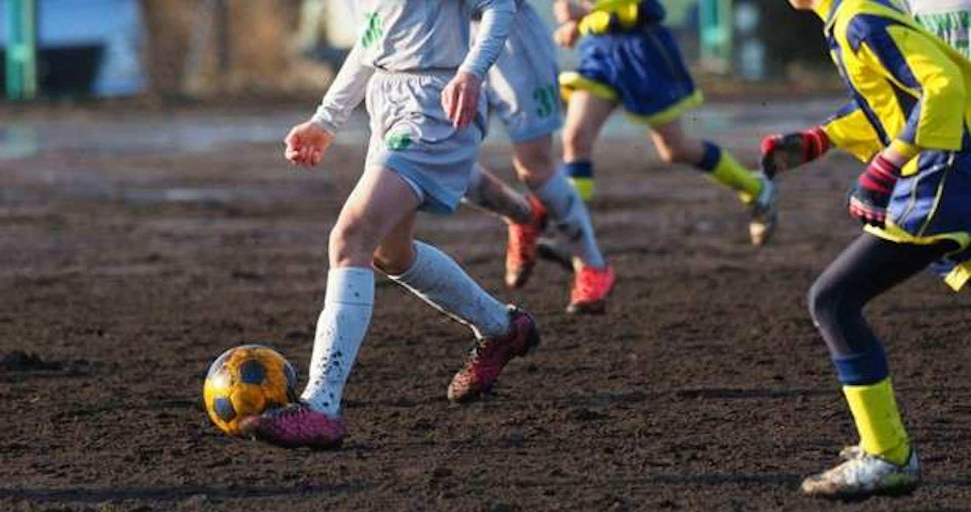 Teams playing football in a pitch