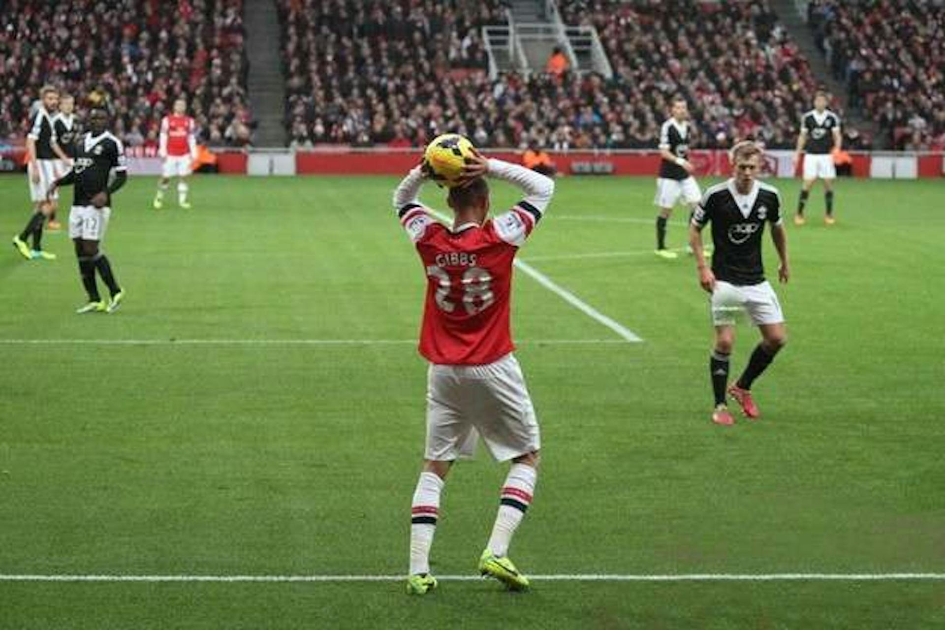 A football player carries out a throw-in