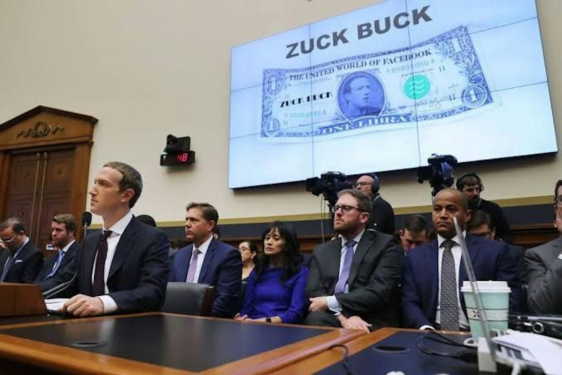 Dante Disparte seated directly behind Meta Founder Mark Zukerberg at the 2019 Congressional Hearing on Libra   
