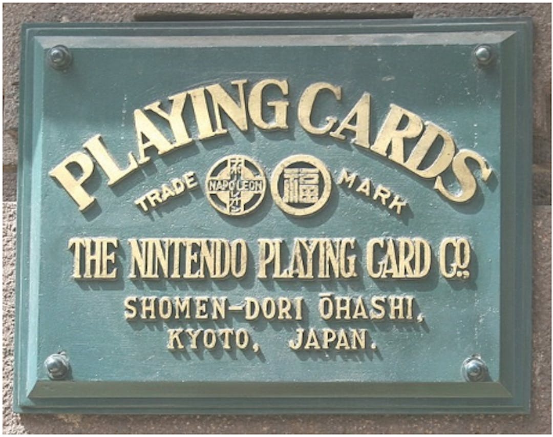 Nintendo’s Old Headquarter Nameplate: Image Credit : Eckhard Pecher | Edited by Smuckola | CC BY 2.5, Link | Wikimedia Commons | 
