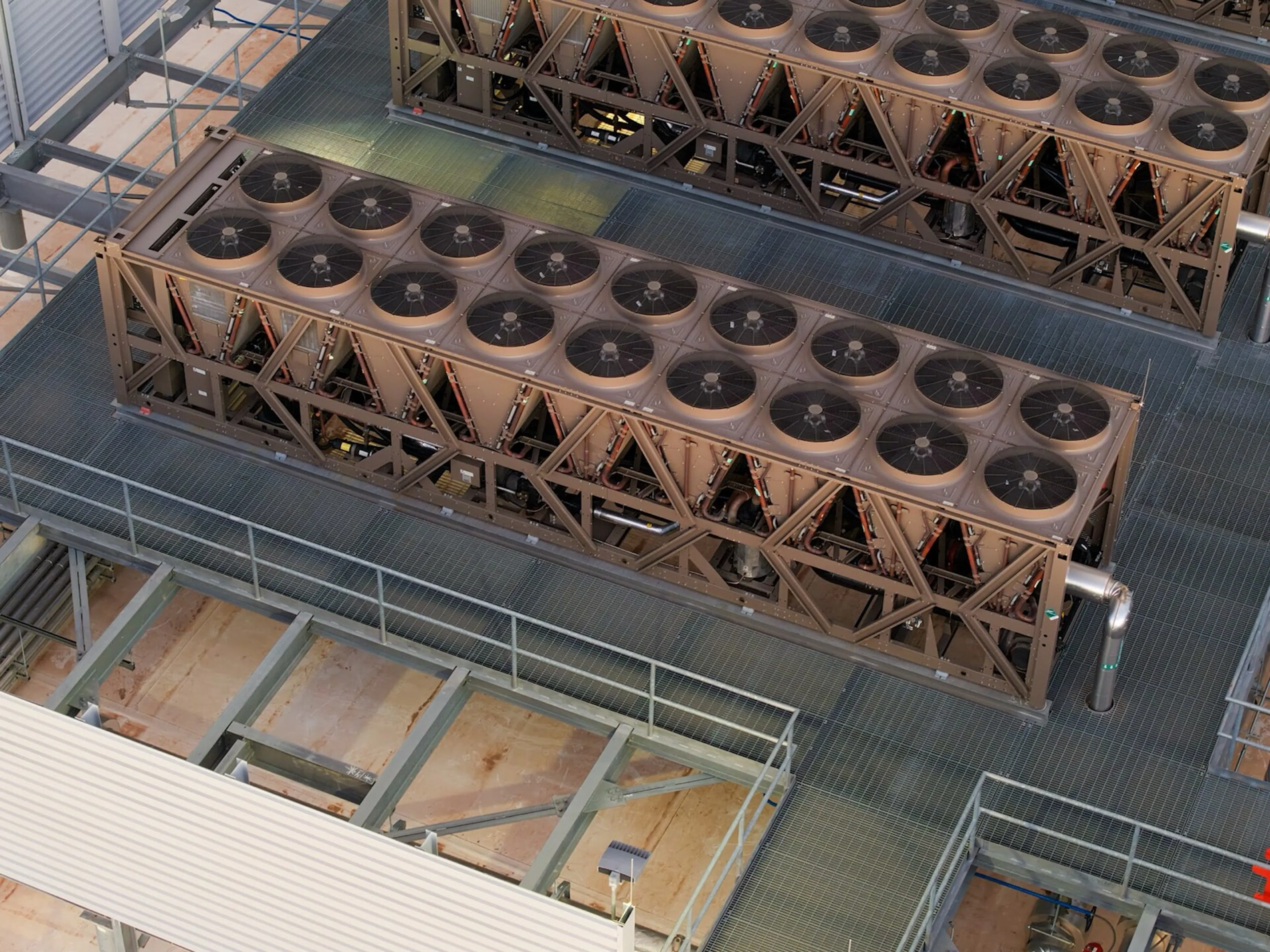 Rows of fan-topped heat rejection units on a data center roof deck