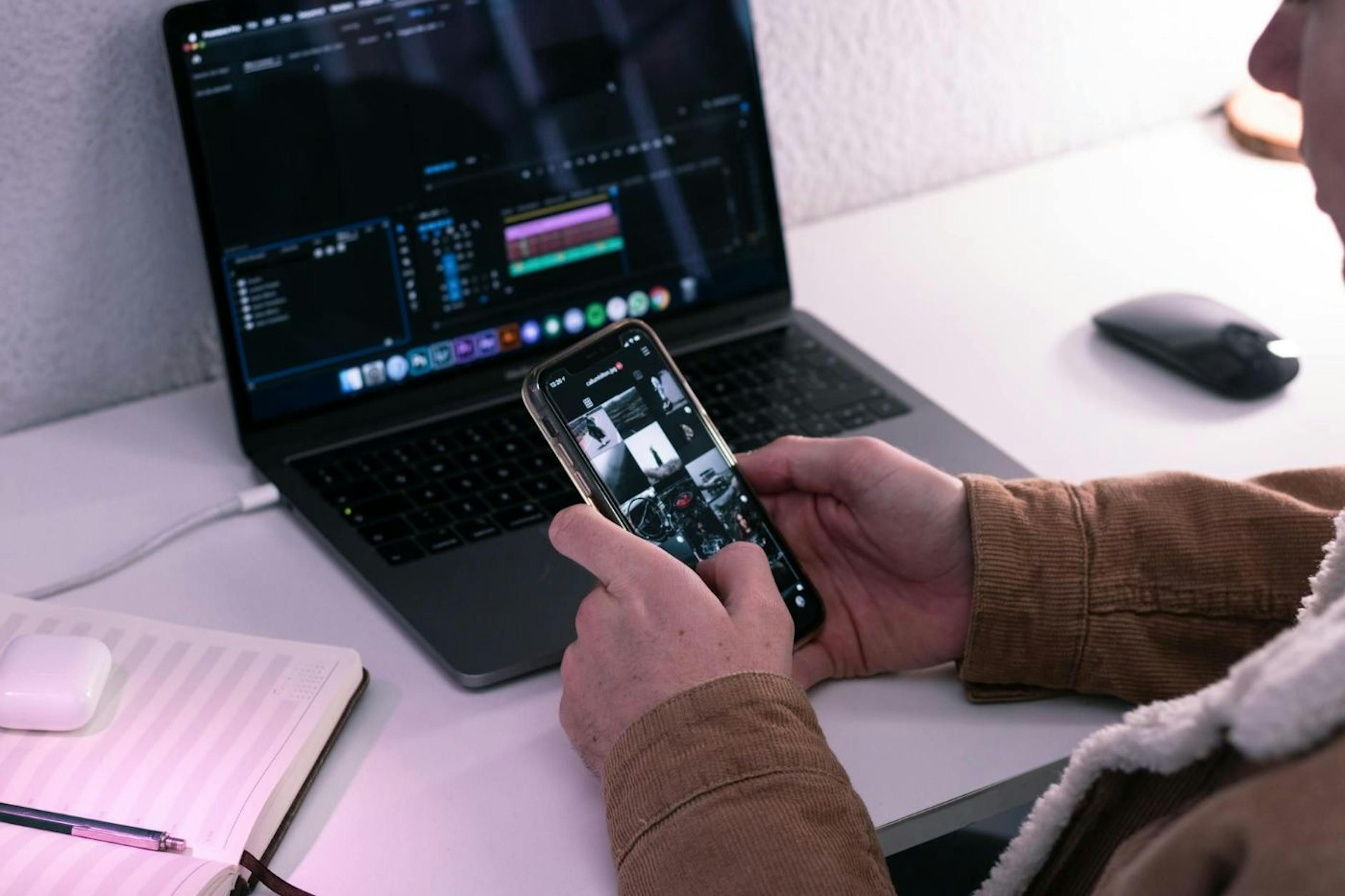 Guy working on phone and computer