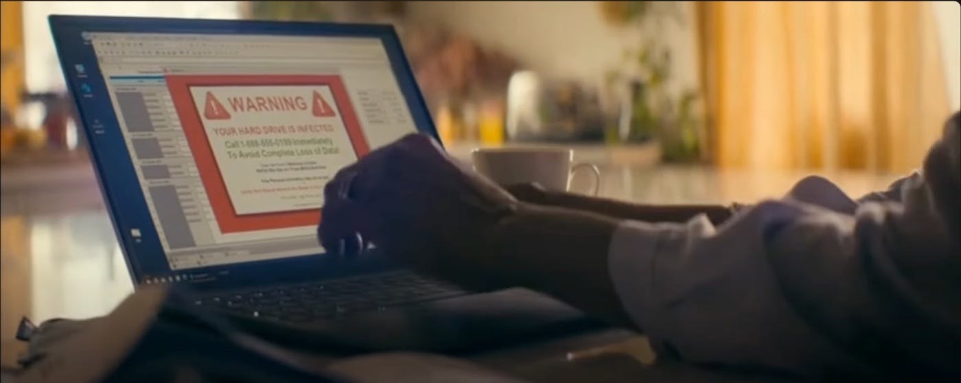 Scene depicting a warning message on a computer screen indicating a malware infection. The Beekeeper (2024). Amazon MGM Studios. Image source: YouTube – official trailer.