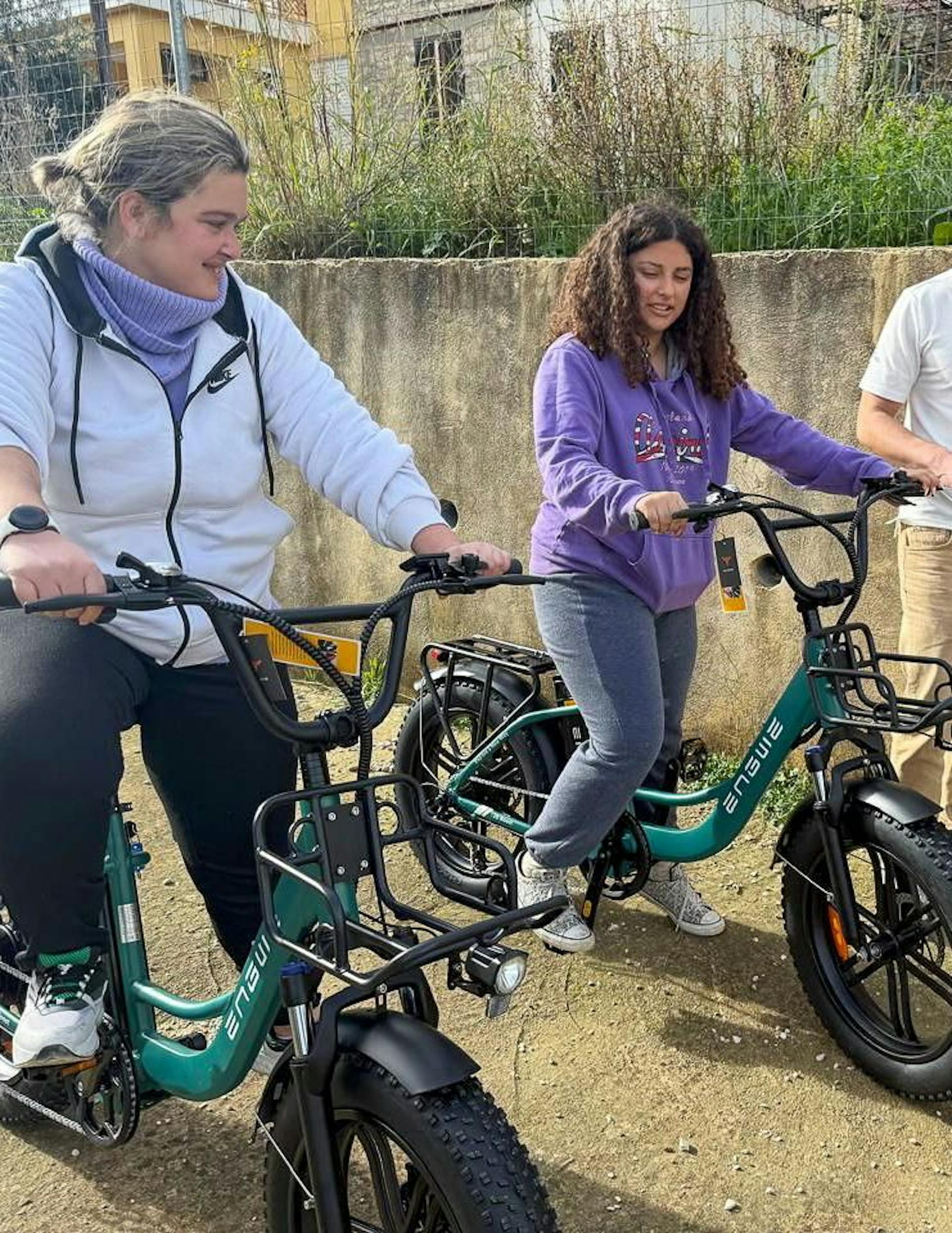 Varvara (on the left) and Christina with big smiles on their faces, enjoying their first ride on the e-bikes.