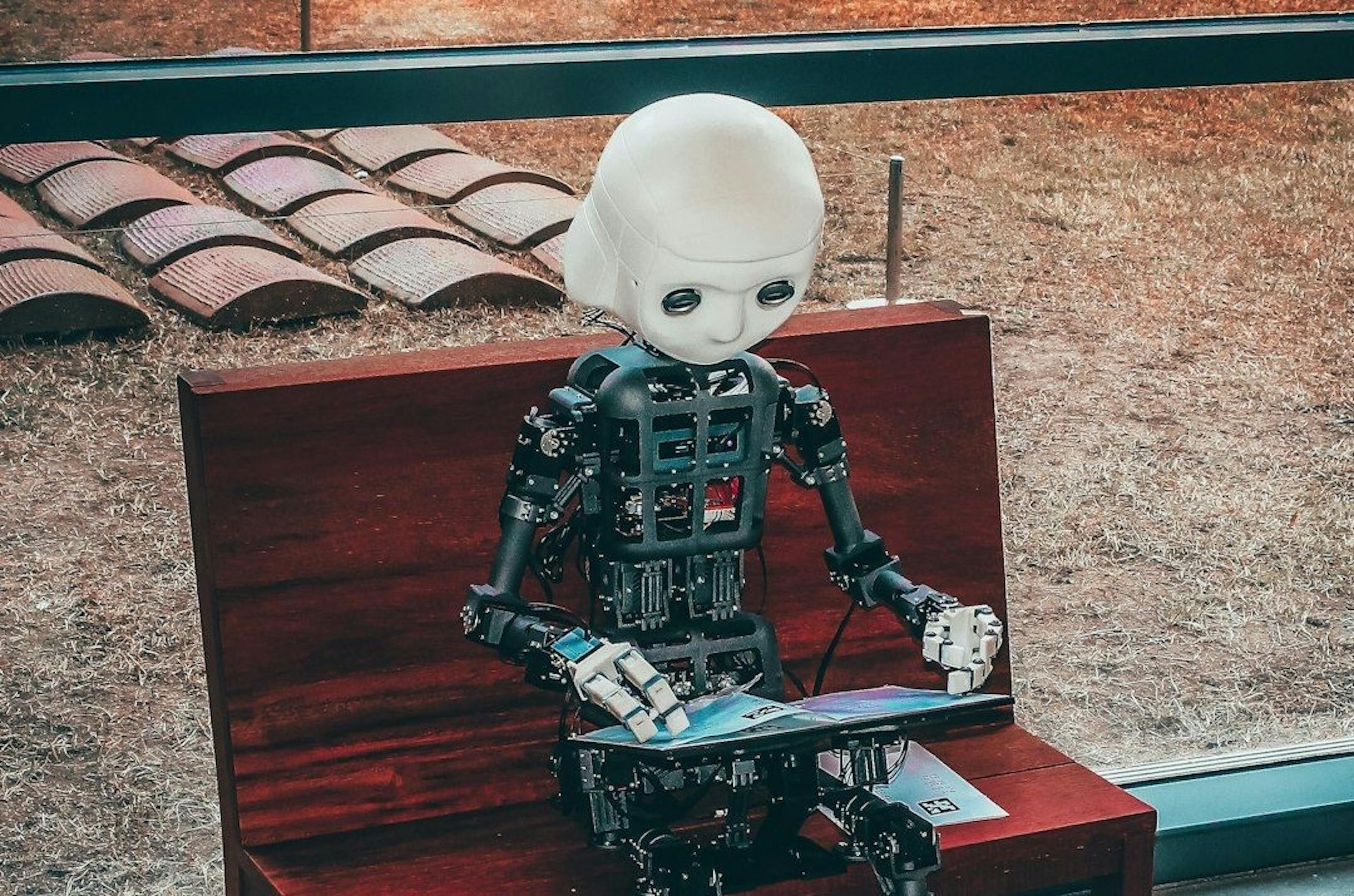 A Robot Working by Andrea De Santis from Unsplash