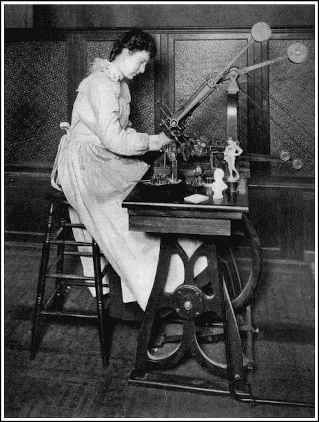 A SMALL WENZEL AUTOMATIC SCULPTURING MACHINE
This cuts statuettes, two at a time, out of stone or wood, the cutters being guided by a pointer passed over the surface of the model by the girl.