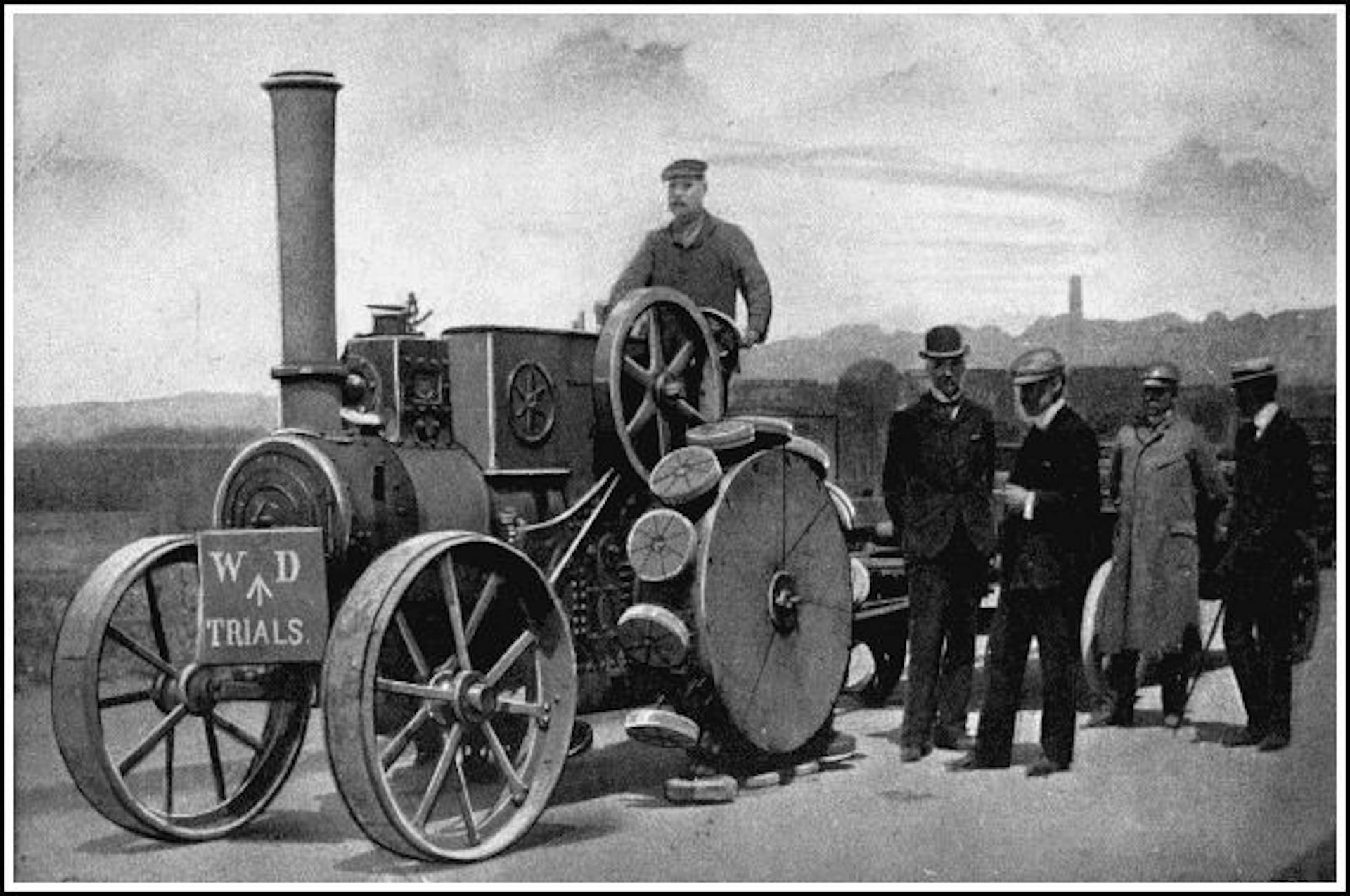 A PEDRAIL TRACTOR ENGAGED IN WAR OFFICE TRIALS
The inventor, Mr. J. B. Diplock, is standing on the left of the group. Observe the manner in which the feet gradually assume a horizontal position as they approach the ground.