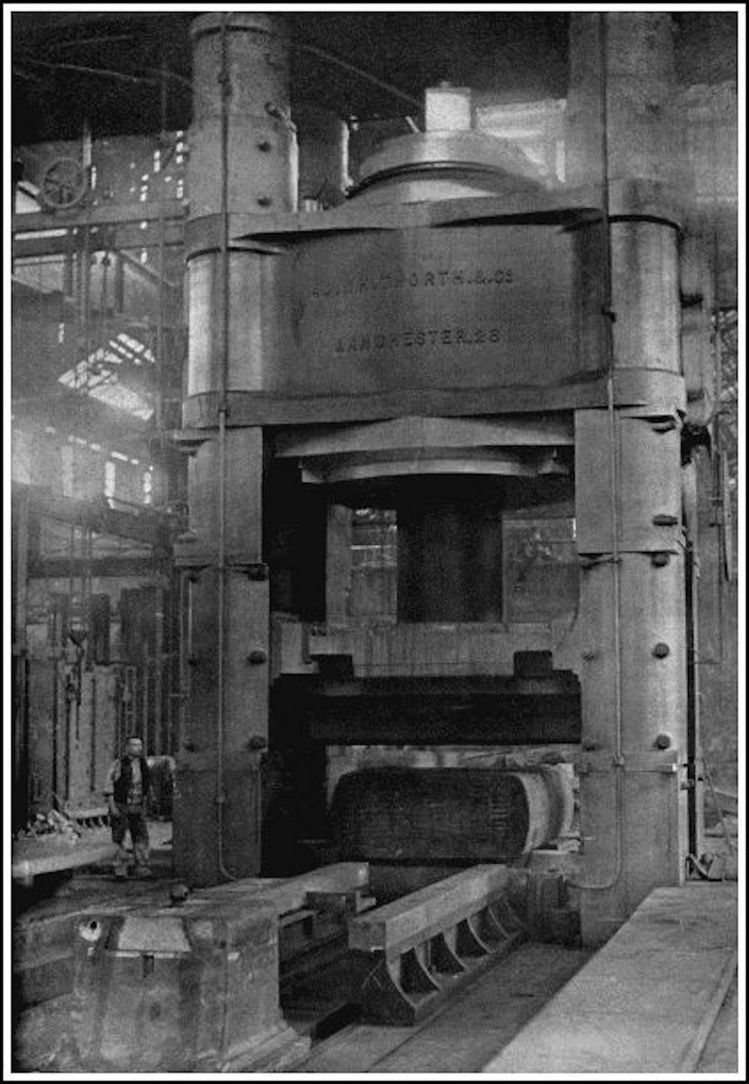 A HUGE HYDRAULIC PRESS
The 12,000-ton pressure Whitworth Hydraulic Press, used for consolidating steel ingots for armour-plating. Water is forced into the ram cylinder at a pressure of three tons to the square inch. Notice the man to the left of the press.